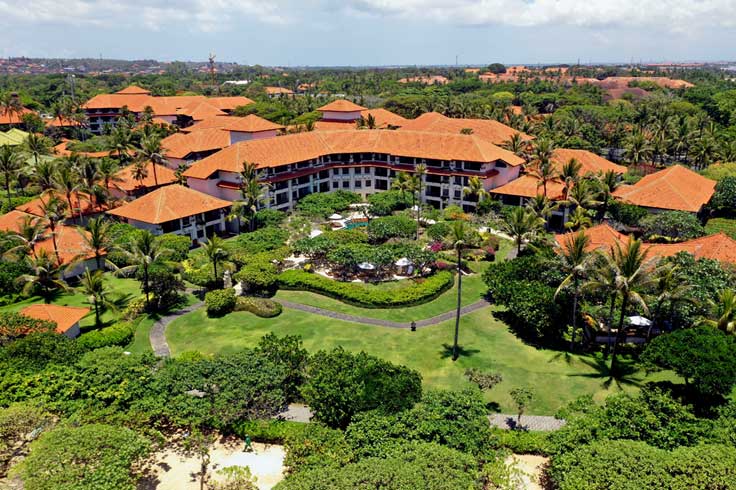 Nusa Dua Bali hotel complex surrounded by green palm trees